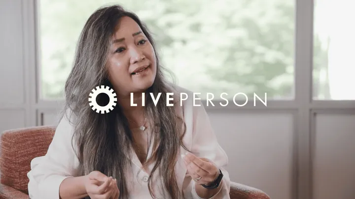 An image of a woman on her laptop overlayed with Customer Story: Telnyx x LivePerson