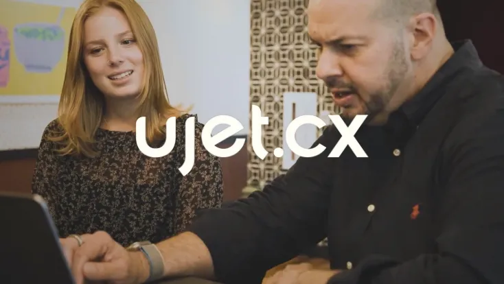 UJET CTO Dave Bullock and coworker behind the UJET logo