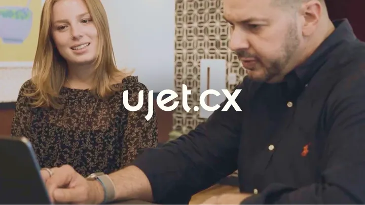 UJET CTO Dave Bullock and coworker behind the UJET logo